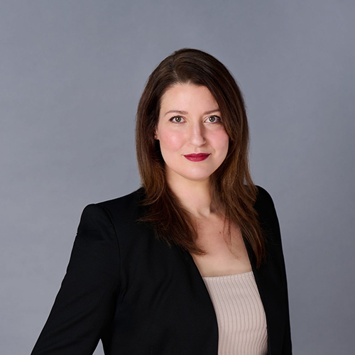 headshot of a women with brown hair in a black blazer